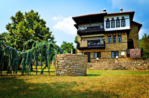 a large stone building in the middle of a field at Archontariki Guesthouse in Poligiros