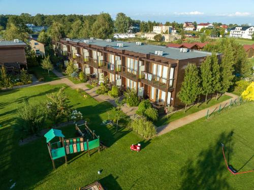 an overhead view of a large building with a playground at Domki Apartamentowe Bueno in Dąbki