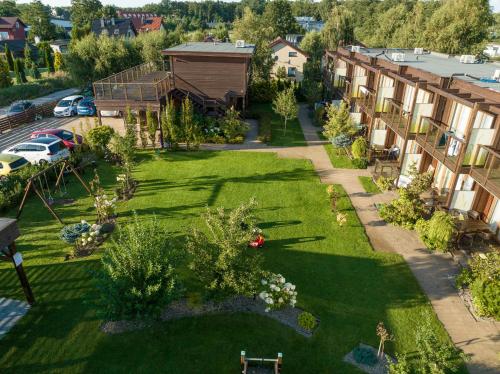 an aerial view of a yard with buildings and grass at Domki Apartamentowe Bueno in Dąbki
