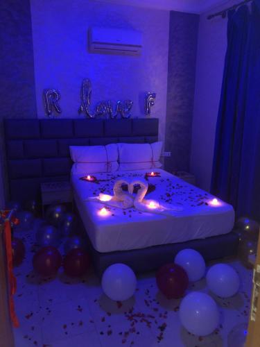 a bedroom with a bed with lights and balloons at Hotel Tidinit in Guelmim