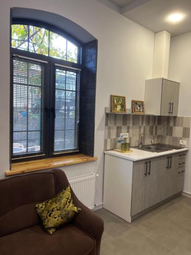 a kitchen with a couch and a sink and a counter at JINJOTEL Gyumri in Gyumri