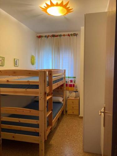 a bedroom with two bunk beds and a light at Apartamento en Montanejos in Montanejos