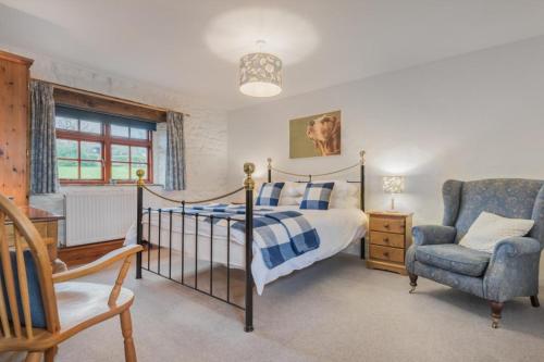 a bedroom with a bed and a chair at 1 Bed in Eden Valley SZ237 in Kirkoswald