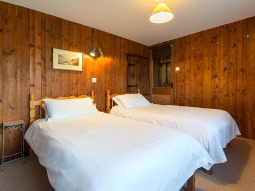 two beds in a room with wooden walls at 2 Bed in Patterdale SZ210 in Patterdale