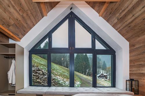 a window in a room with a mountain view at Horská chata Termoska in Rokytnice nad Jizerou