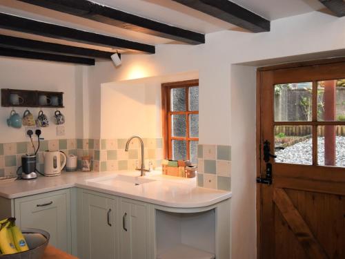 a kitchen with a sink and a window at 3 bed in Eskdale SZ313 in Boot