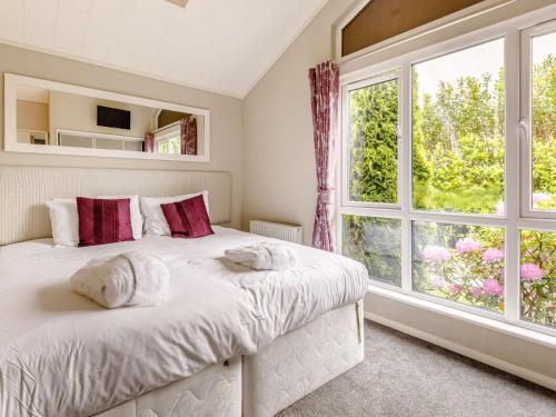 a bedroom with a bed and a large window at 2 Bed in Ilfracombe 87361 in Kentisbury