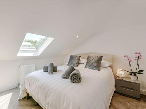 a bedroom with a white bed with a skylight at 1 Bed in Fairlight 88470 in Fairlight