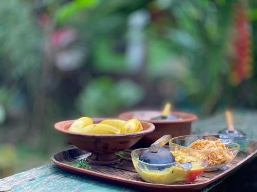 a tray with bowls of food on a table at Evergreen Villa Nature Resort in Anuradhapura