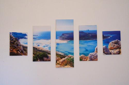 a group of four pictures hanging on a wall at Appartamento Cialdini Centro Ancona in Ancona