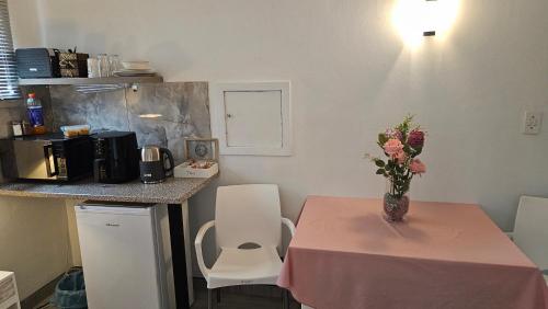 a table with a vase of flowers on top of it at The Haven: Make our Home your Home in Estcourt
