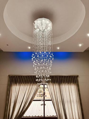 a large chandelier hanging from a ceiling at Hotel Destiny in Ongwediva