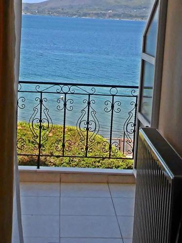 a view of the ocean from a balcony at Hotel Romantica in Loutra Edipsou