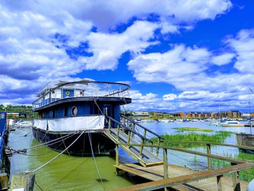 a boat is docked at a dock in the water at Inner Dowsing Lightship in Rochester