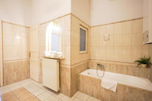 een badkamer met een bad en een raam bij Unio Apartment in Boedapest
