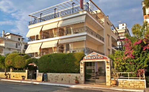 a tall building with a sign in front of it at Hotel Romantica in Loutra Edipsou