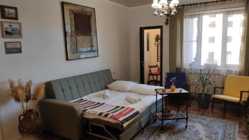 a bedroom with a bed and a table and chairs at Apartment 11 in Gyumri