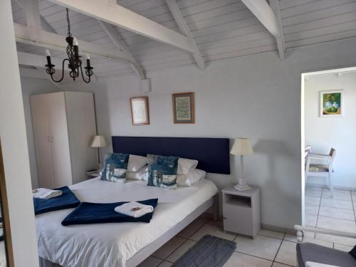 a bedroom with a bed with a blue head board at Paters Haven Self-catering and B&B in Paternoster