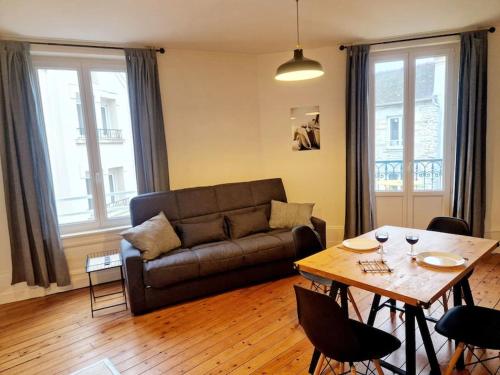 un salon avec un canapé et une table dans l'établissement Le Flambart, à Cherbourg en Cotentin