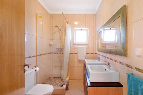 een badkamer met een wastafel, een douche en een toilet bij Casa Palma in Paderne