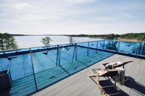 a swimming pool on the deck of a house at Apartamenty Boszkowo Lake Harbor in Boszkowo