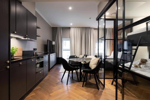 a kitchen and dining room with a table and chairs at Bob W Koti Katajanokka in Helsinki