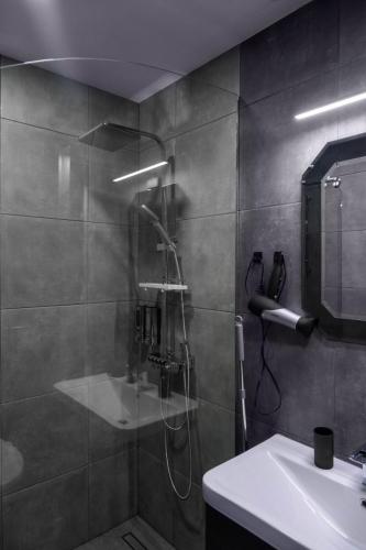 a bathroom with a shower and a sink at Gudauri premium apartments in Gudauri