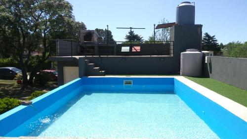 a swimming pool in the backyard of a house at Los Ceibos in Villa Carlos Paz
