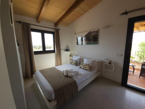 a bedroom with a large bed and a window at Agroturisme Es Racó De Maria in Maria de la Salut