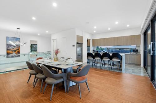 a dining room and kitchen with a table and chairs at Amazing Backyard - MAX Entertain Beachside Retreat in Tootgarook