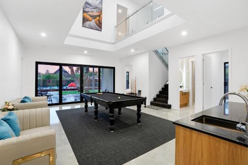a living room with a pool table in it at Amazing Backyard - MAX Entertain Beachside Retreat in Tootgarook