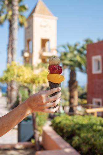 a person holding up a ice cream cone at Candia Park Village in Agios Nikolaos