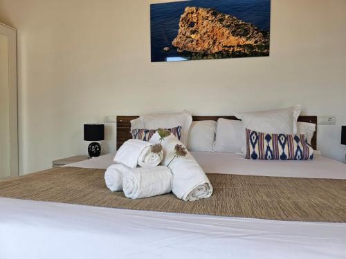 a bedroom with a bed with towels on it at Agroturisme Es Racó De Maria in Maria de la Salut