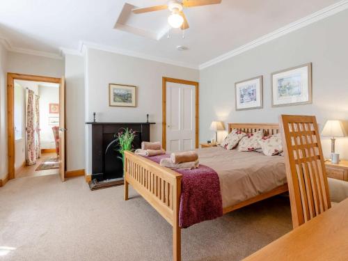 a bedroom with a large bed and a fireplace at 1 Bed in St Andrews 45667 in Ladybank