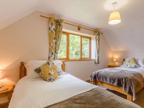 a bedroom with two beds and a window at 3 bed in Worcester CC037 in Clifton upon Teme