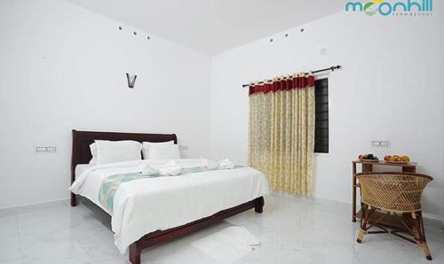 een witte slaapkamer met een bed en een stoel bij FabHotel Prime Moon Hill Resorts in Munnar