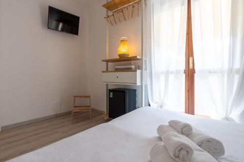 a bedroom with a white bed with towels on it at Hotel Germania in Lido di Jesolo