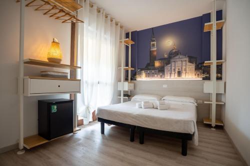 a bedroom with a bed with a picture of a city at Hotel Germania in Lido di Jesolo