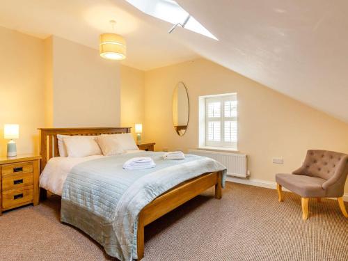 a bedroom with a large bed and a chair at 9 Bed in Buxton 57932 in Buxton