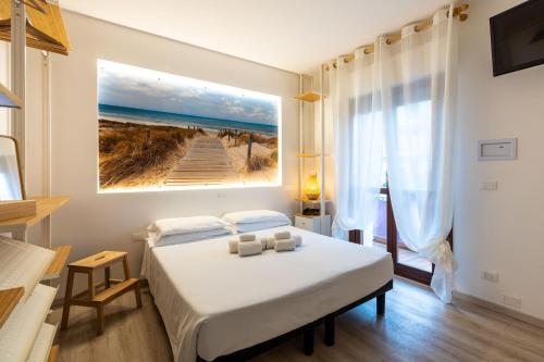 a bedroom with a bed and a painting of a beach at Hotel Germania in Lido di Jesolo
