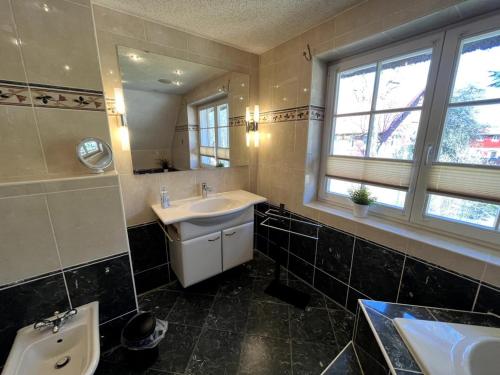 a bathroom with a sink and a toilet and a mirror at Ferienhaus Fiete in Wieck in Wieck