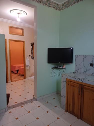 sala de estar con TV de pantalla plana en la pared en Apartement privé en Taroudant