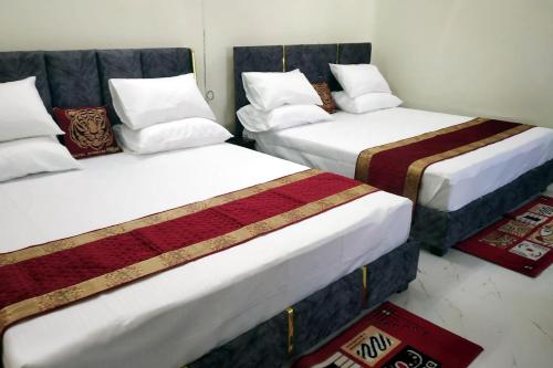 two beds in a room at Creeper Hotel And Restaurant in Rohtak