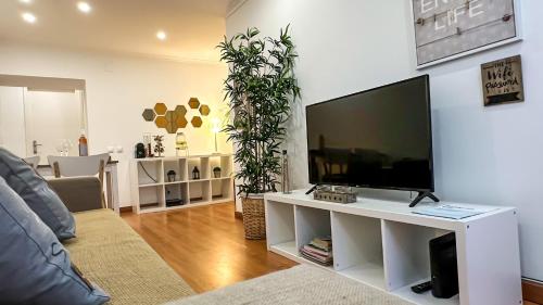 a living room with a large flat screen tv at T2 Apartment -Cascais center - 100m from beach in Cascais