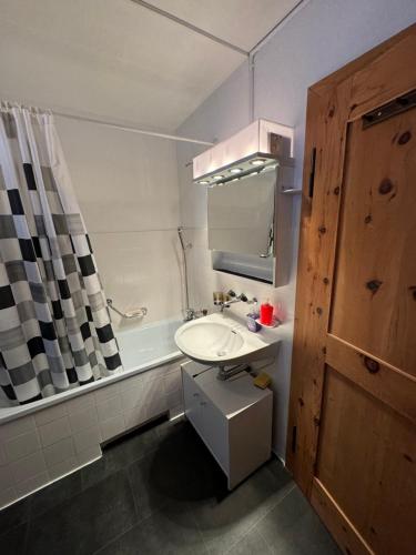 a bathroom with a sink and a bath tub at Flumserberg in Flumserberg