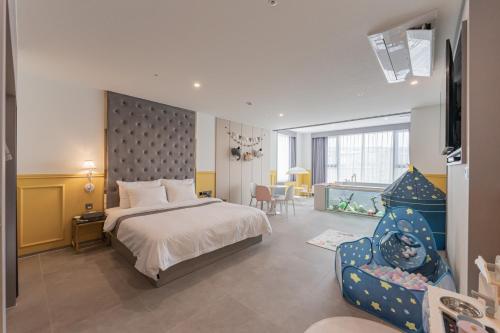a hotel room with a bed and a chair at Yeongdo Grandbern Hotel in Busan