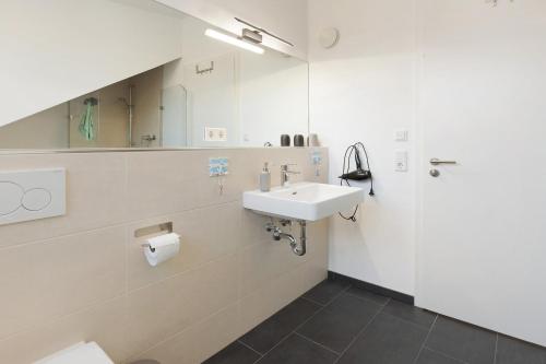 a bathroom with a sink and a mirror at Traum mit Seeblick in Allensbach
