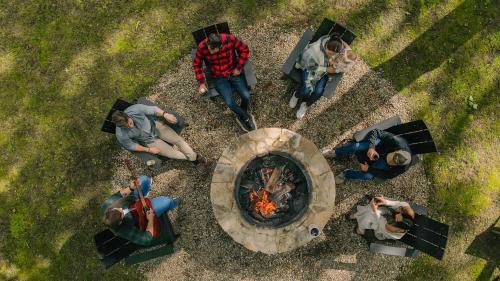 a group of people sitting around a fire pit at Hotel Cashiers in Cashiers