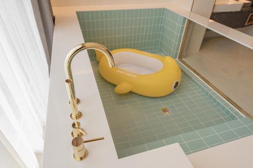 a toy duck in a bathroom with a sink at Yeongdo Grandbern Hotel in Busan