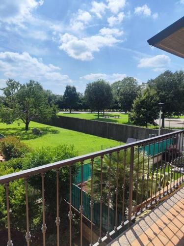 a balcony with a view of a green park at Rovato entire apartment in the capital of Franciacorta in Rovato